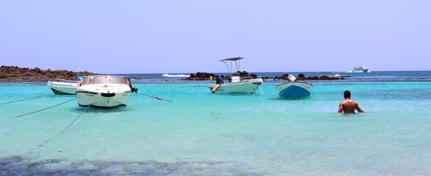 Zach walking into clear blue waters