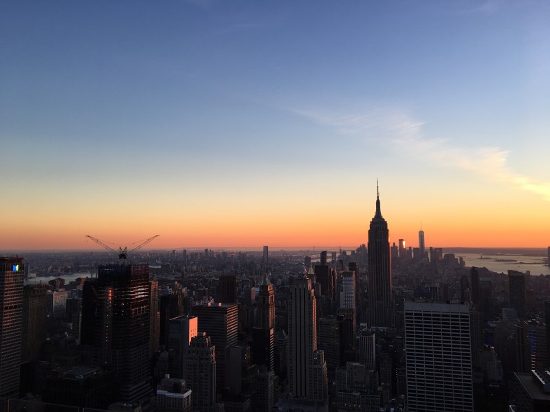 Sunset over new york city with view of empire state building.