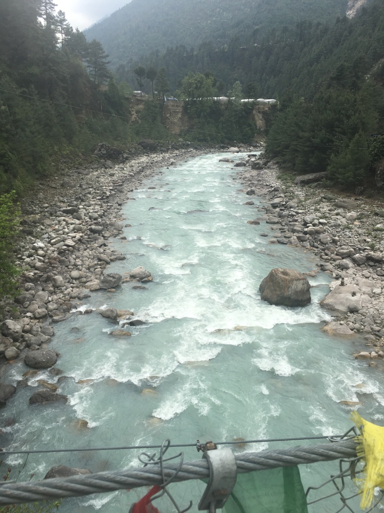 View of river under suspension bridge to Phakding